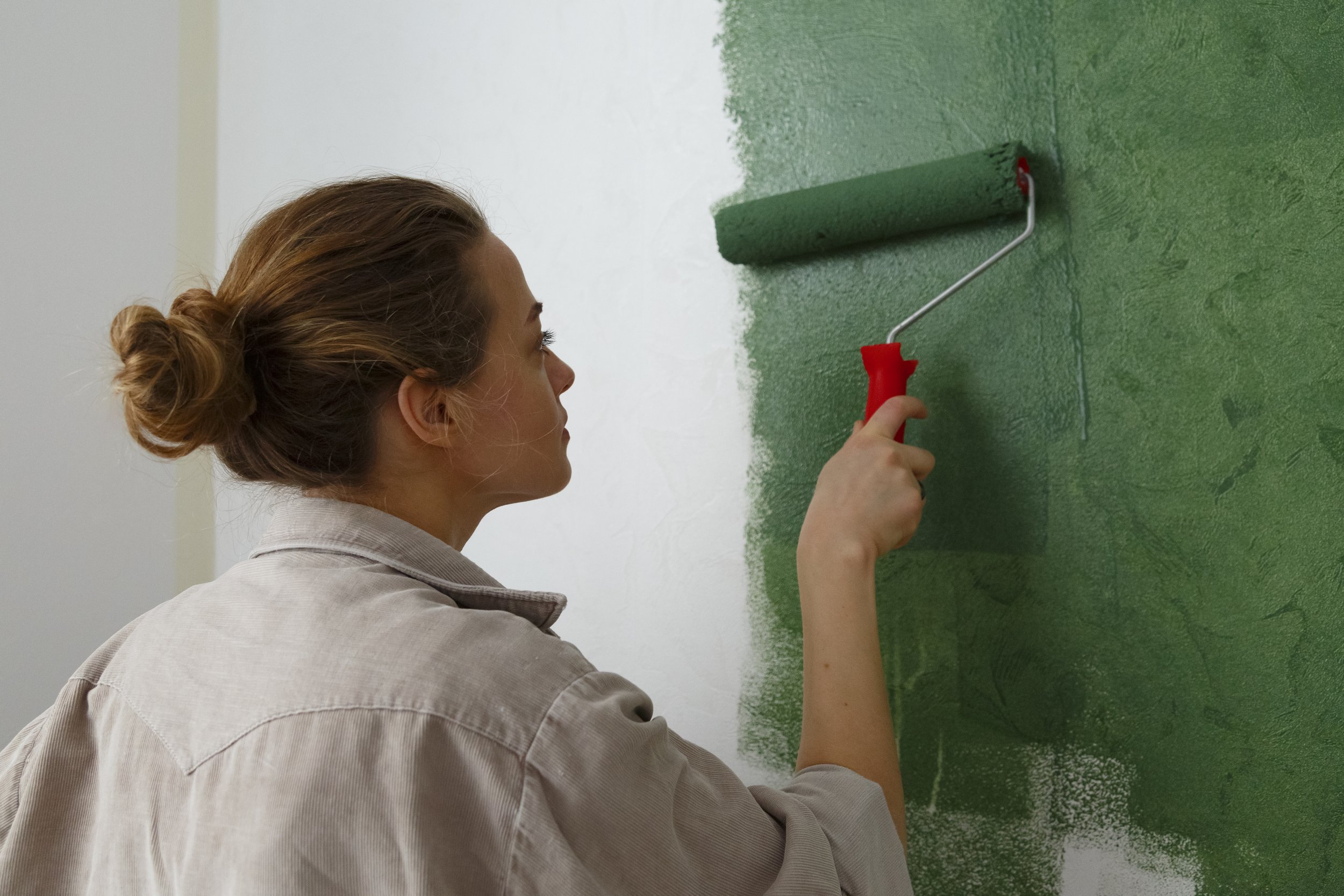 Woman painting a wall